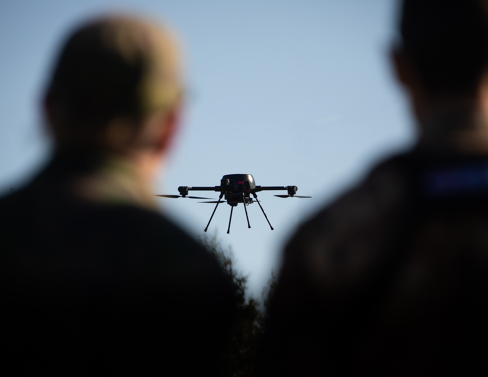 PATRIA drone flying in front of two drone operators