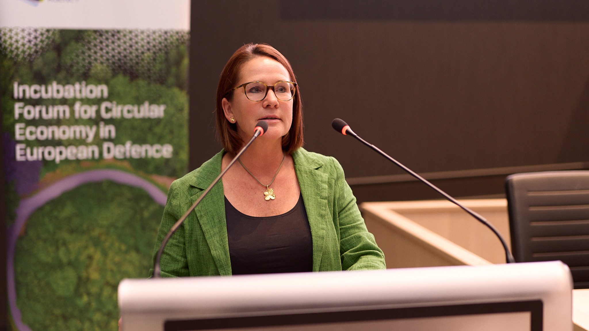 Yuriko Backes talking from podium to the audience